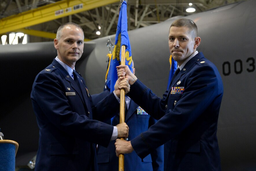 Maj. Jeffrey Anderson assumes command of the 2nd Maintenance Squadron from Col. David Foote, 2nd Maintenance Group commander, during a change of command ceremony at Barksdale Air Force Base, La., June 26, 2015. Anderson was previously the Air Force Global Strike Command directorate of logistics, installations and mission support at AFGSC headquarters, here, where he directed the command’s conventional munitions programs and managed munitions maintenance and accountability for logistics matters. (U.S. Air Force photo/ Senior Airman Jannelle Dickey)