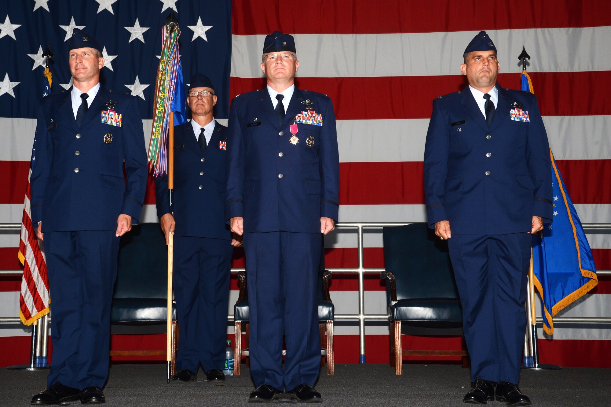 (From left) U.S. Air Force Cols. Stephen Jost, 20th Fighter Wing commander, Paul Murray, 20th Operations Group outgoing commander, and Douglas Thies, 20th OG incoming commander, stand at attention during the reading of the change of command orders at the 20th OG change of command ceremony at Shaw Air Force Base, S.C., June 26, 2015. The 20th OG is comprised of four squadrons, housing more than 80 F-16CM Fighting Falcons, making the 20th FW the Air Force’s largest F-16 combat wing. (U.S. Air Force photo by Senior Airman Jonathan Bass/Released)