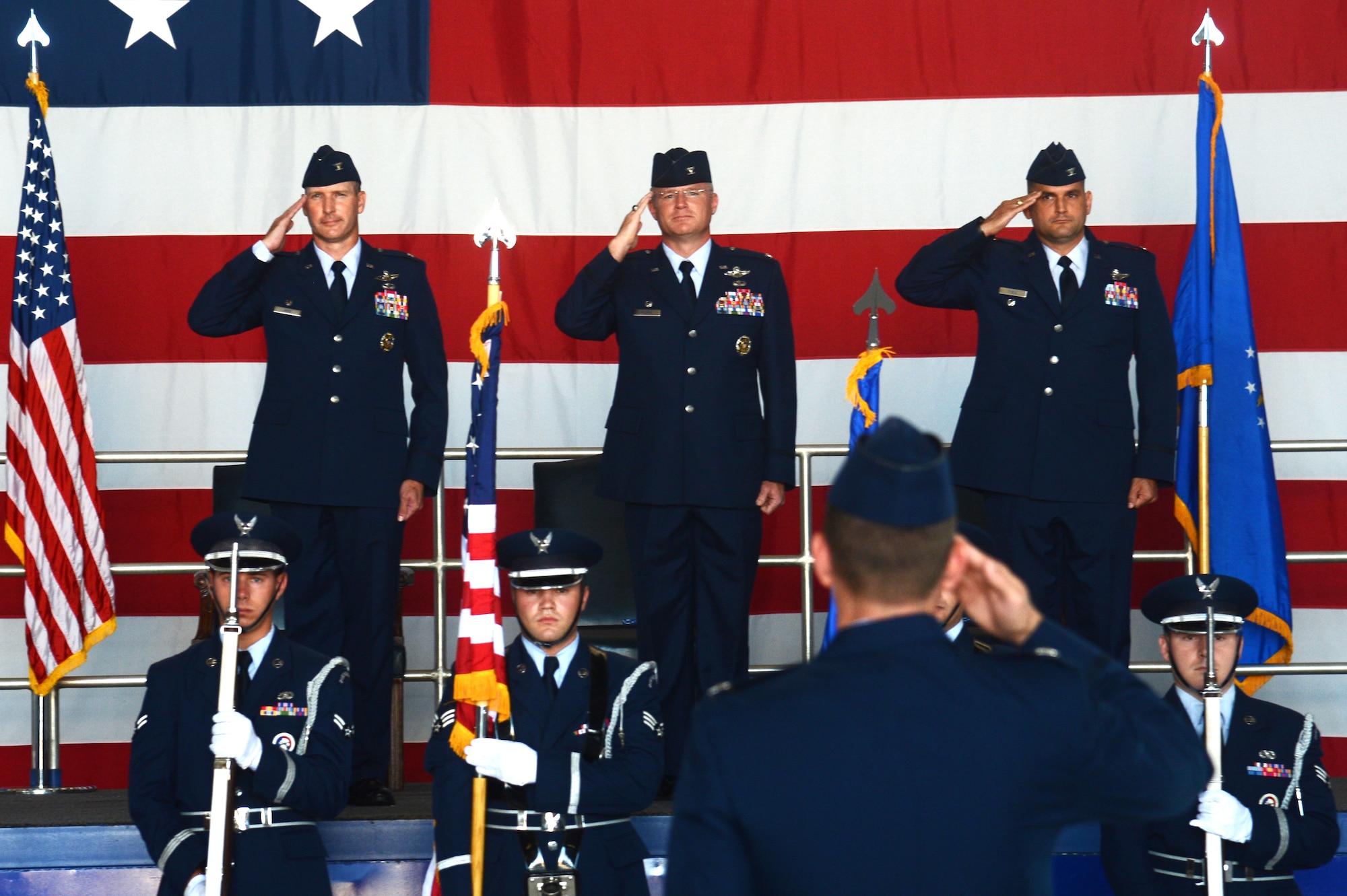 (From left) U.S. Air Force Cols. Stephen Jost, 20th Fighter Wing commander, Paul Murray, 20th Operations Group outgoing commander, and Douglas Thies, 20th OG incoming commander, render salutes during the national anthem at the 20th OG change of command ceremony at Shaw Air Force Base, S.C., June 26, 2015. The change of command ceremony is a time-honored tradition dating back to 18th century Prussia. (U.S. Air Force photo by Senior Airman Jonathan Bass/Released)