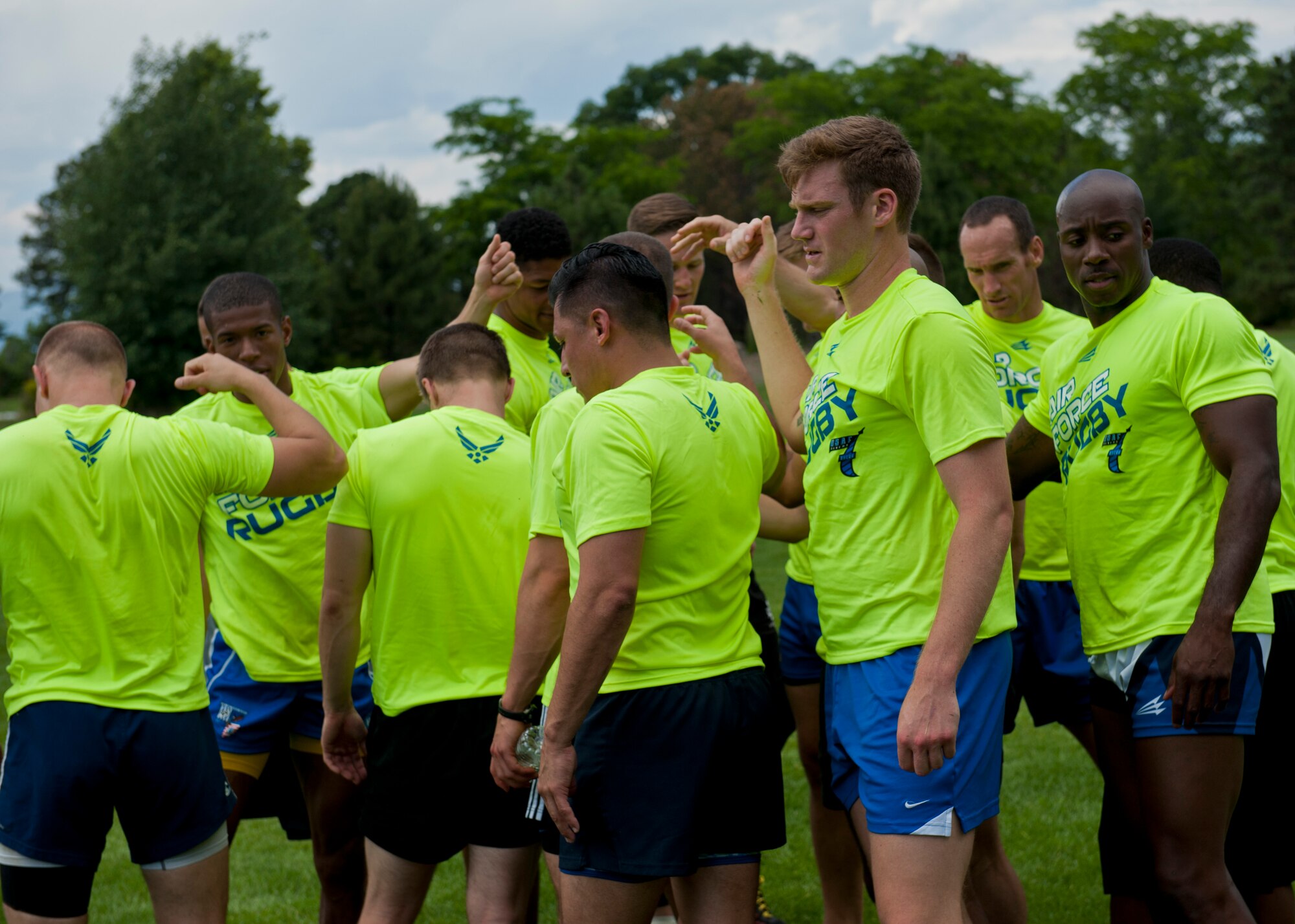PETERSON AIR FORCE BASE, Colo. – The Air Force Rugby team brings their hands in to break for the day after an intense practice at Patriot Park on June 25, 2015. The team is from bases around the Air Force, and came together to get in some good team practice before a tournament in Denver on June 27, 2015. (U.S. Air Force photo by Airman 1st Class Rose Gudex)