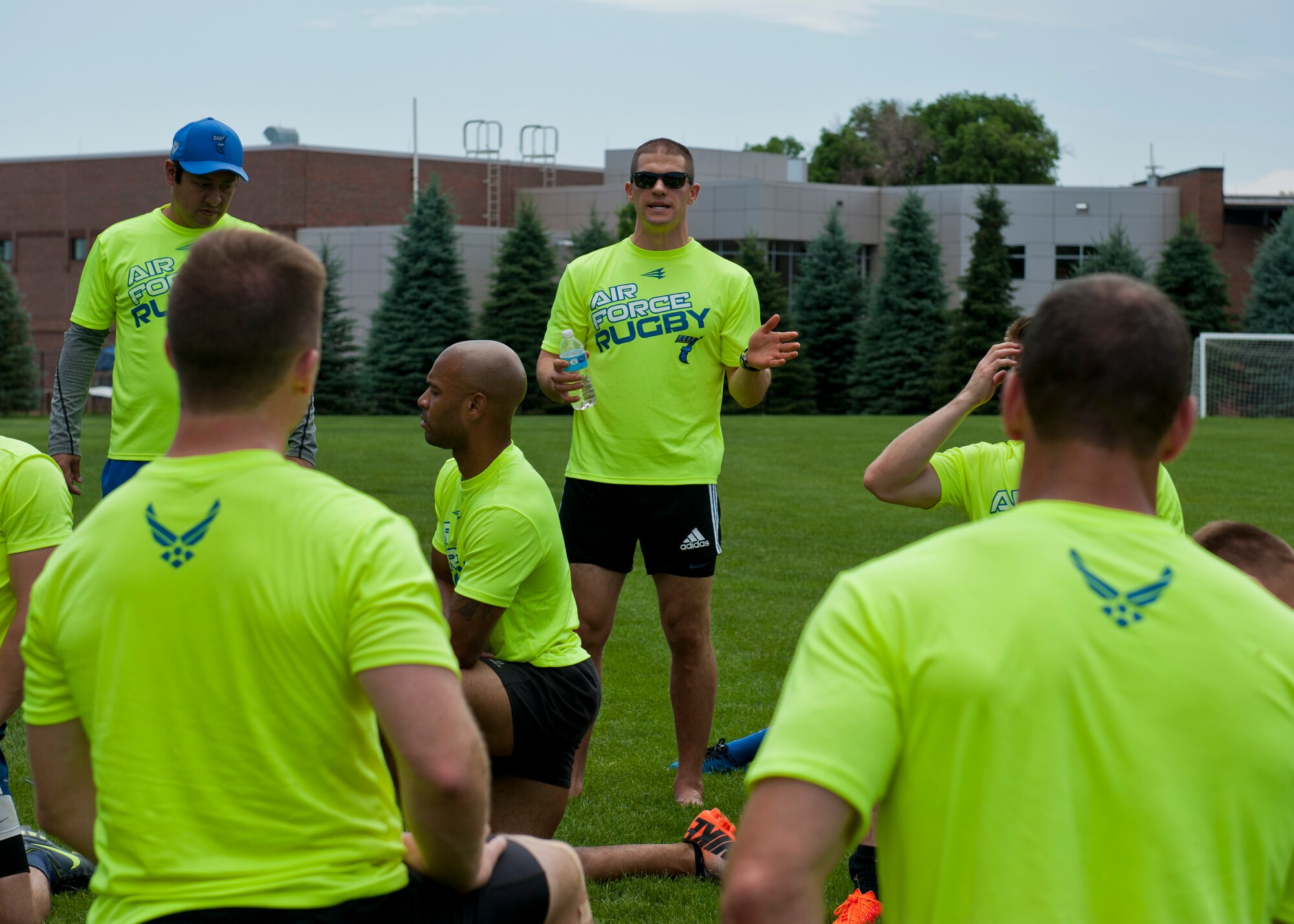 PETERSON AIR FORCE BASE, Colo. – A coach from the Air Force Rugby team addresses the members after a hard practice in the sweltering sun at Patriot Park, June 25, 2015. The team came to Peterson to prepare for a civilian rugby tournament in Denver on June 27, 2015. (U.S. Air Force photo by Airman 1st Class Rose Gudex).