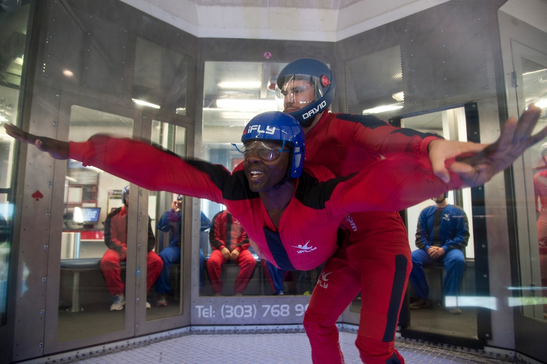 DENVER, Colo. – Senior Airman JoJuan Green, 21st Operations Support Squadron weapons and tactics, flies in the wind tunnel at IFly Indoor Skydiving during a Peterson Chapel retreat, June 19, 2015. Peterson leadership picked their top performers to participate in a day retreat to indoor skydive, eat lunch and discuss the stress of military life and resources available. (U.S. Air Force photo by Senior Airman Tiffany DeNault)