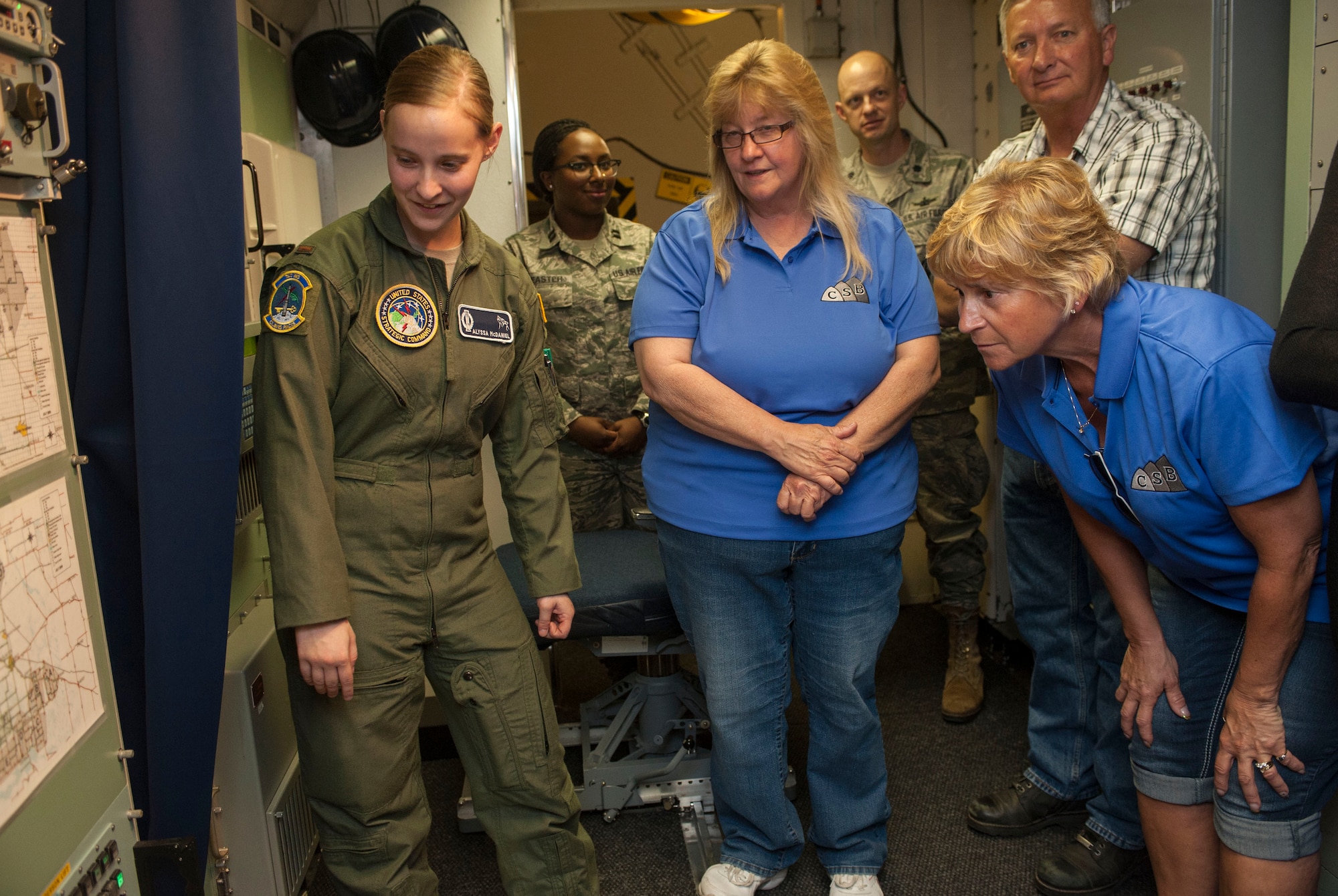 2nd Lt. Alyssa McDaniel, 742nd Missile Squadron deputy missile combat crew commander, reviews a map of the missile complex with civic leaders from the town of Mohall, during a tour at the Juliet 01 Missile Alert Facility near Minot Air Force Base, N.D., June 25, 2015.  The tour was part of a civic outreach program created by the 91st Missile Wing to educate the residents of the towns near MAFs on the mission of the Airmen working there. (U.S. Air Force photo/Senior Airman Stephanie Morris)