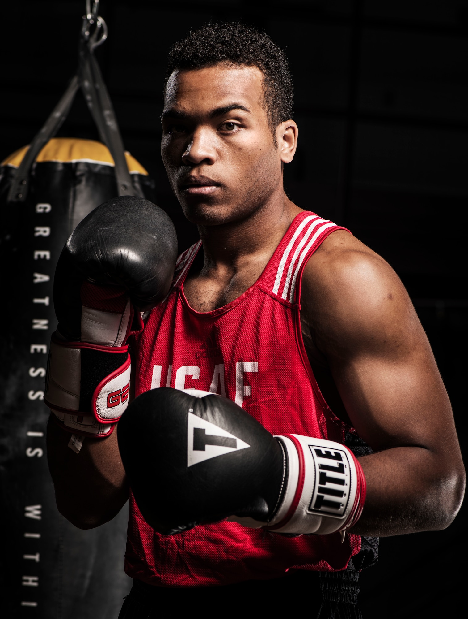Senior Airman Martin E. Bills III, 366th Security Forces Squadron response force leader, poses for a photo at the Fitness Center Annex at Mountain Home Air Force Base, Idaho, April 18, 2015. Bills made the All Air Force Boxing Team at the beginning of the year. (U.S. Air Force photo illustration by Airman 1st Class Jeremy L. Mosier/Released)
