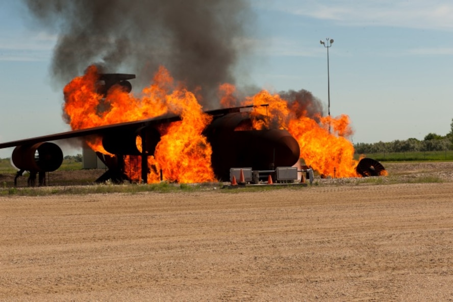 A model aircraft burns during a live fire exercise performed at Minot Air Force Base, N.D., June 26, 2015. Live fire exercises help CE Airmen test their response skills in an emergency situation. (U.S. Air Force photo/Airman 1st Class Christian Sullivan)