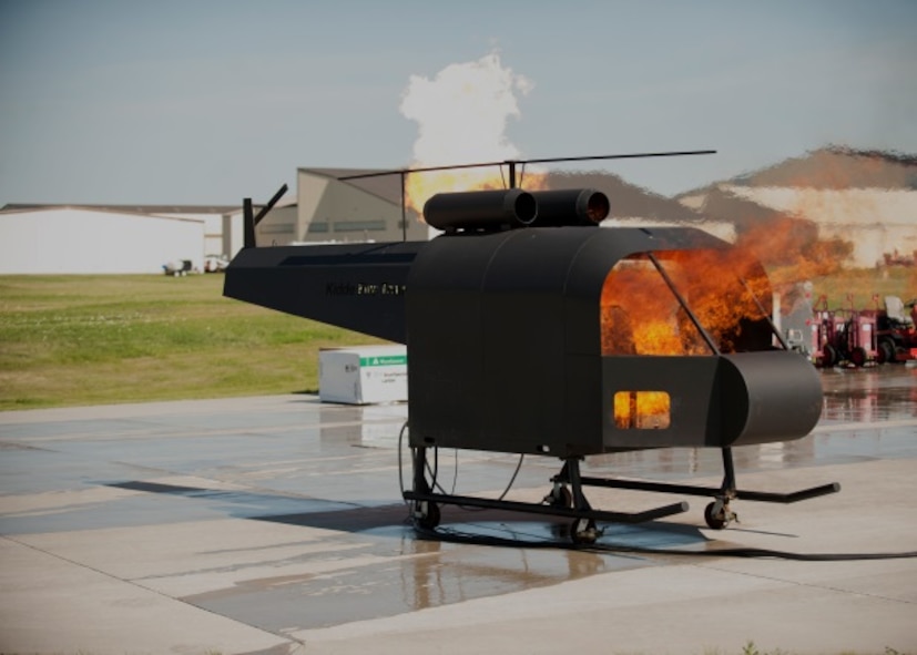 The 5th Civil Engineer Squadron sets fire to its new model helicopter, which is used for live fire exercises at Minot Air Force Base, N.D., June 26, 2015. Live fire exercises help CE Airmen test their response skills in emergency situations. (U.S. Air Force photo/Airman 1st Class Christian Sullivan)
