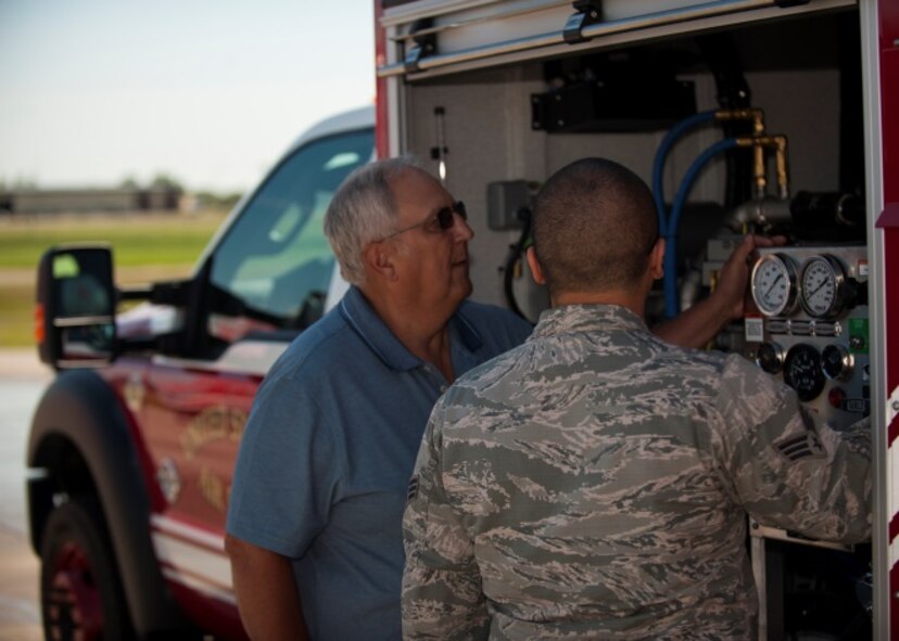 A former Minot Air Force Base fireman receives a tour from a current fireman at Minot AFB, N.D., June 26, 2015. The Base held a firefighter reunion to honor former firefighters and to show them what capabilities Minot firemen have. (U.S. Air Force photo/Airman 1st Class Christian Sullivan)
