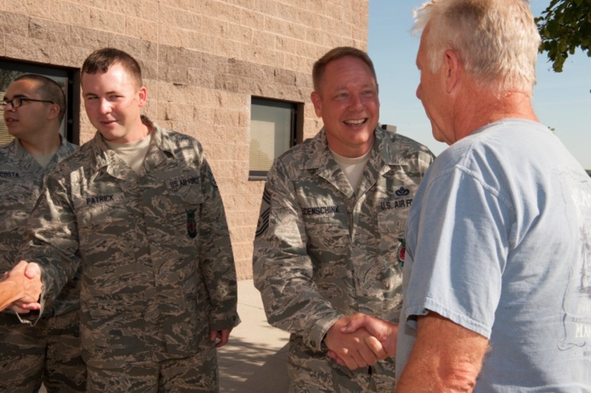 Chief Master Sgt. Russell Eidenschink, 5th Civil Engineer Squadron fire chief, greets retired Minot Air Force Base firefighters at Minot AFB, N.D., June 26, 2015. Minot held a firefighter reunion to honor former firefighters to show them what capabilities Minot firemen have. (U.S. Air Force photo/Airman 1st Class Christian Sullivan)