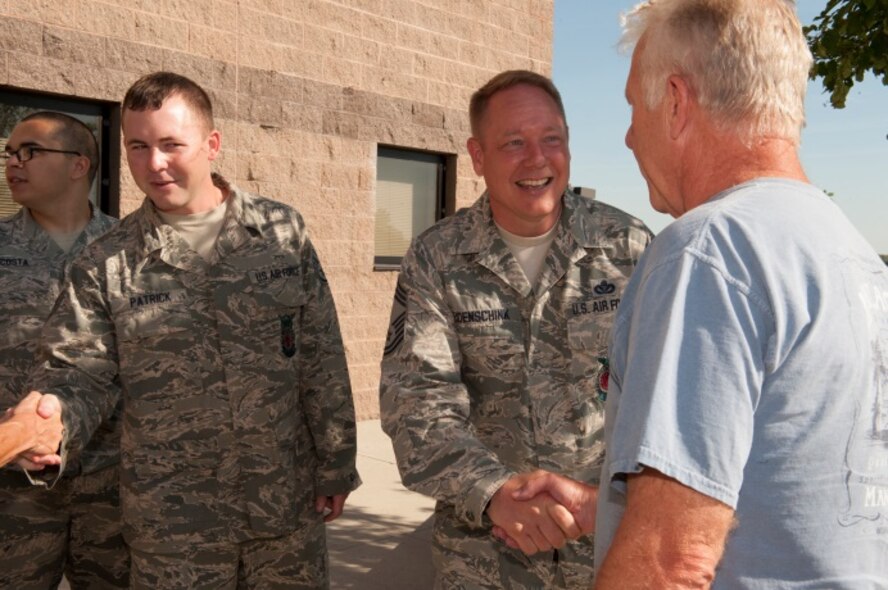Chief Master Sgt. Russell Eidenschink, 5th Civil Engineer Squadron fire chief, greets retired Minot Air Force Base firefighters at Minot AFB, N.D., June 26, 2015. Minot held a firefighter reunion to honor former firefighters to show them what capabilities Minot firemen have. (U.S. Air Force photo/Airman 1st Class Christian Sullivan)