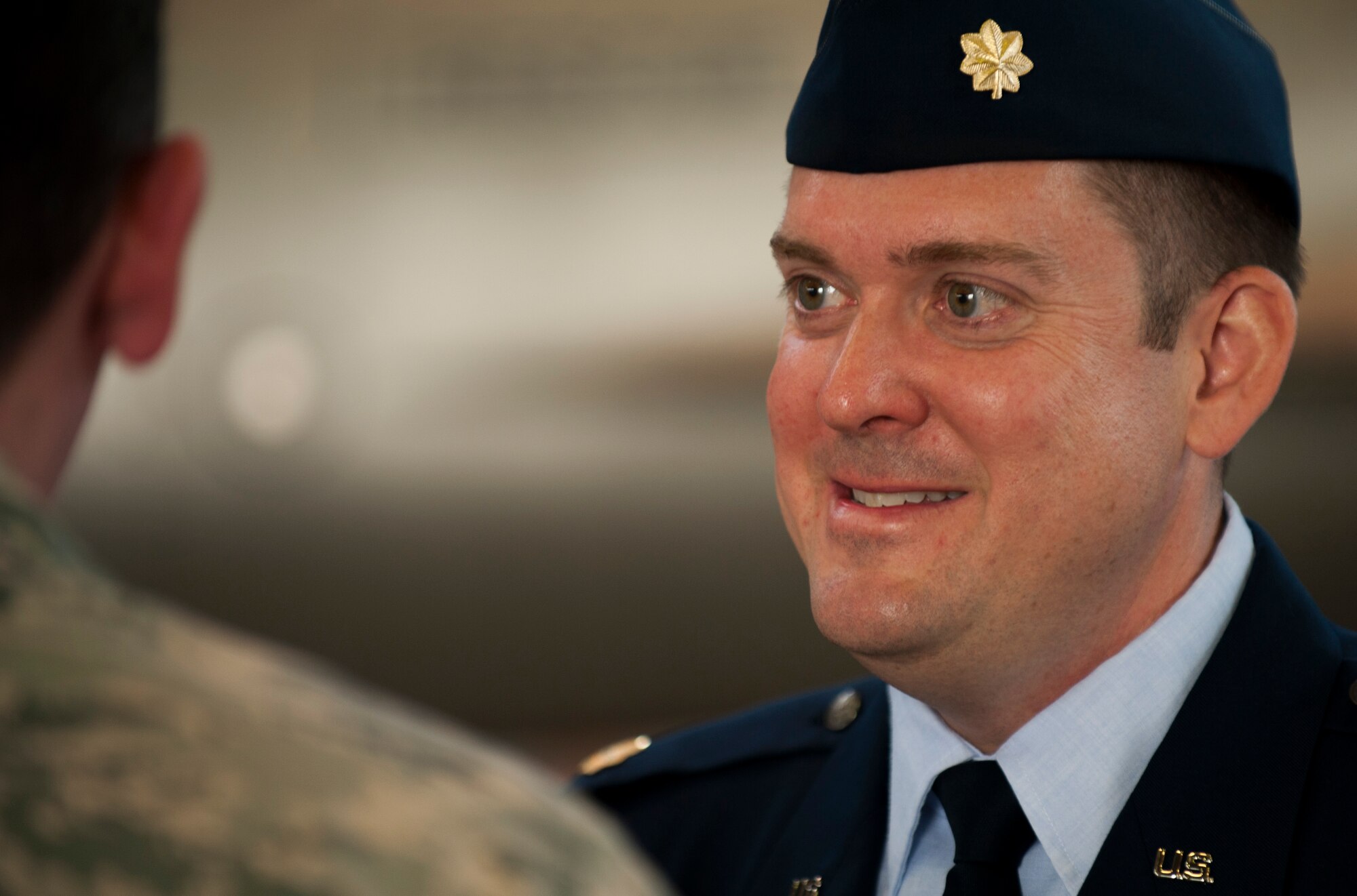 U.S. Air Force Maj. Neil Harris, 52nd Comptroller Squadron commander, greets members of the Spangdahlem community after the 52nd CPTS change of command ceremony in Hangar One on Spangdahlem Air Base, Germany, June 26, 2015. Family members of both the outgoing and the incoming commanders attended the ceremony and received floral bouquets as a symbol of gratitude for their support. (U.S. Air Force photo by Airman 1st Class Timothy Kim/Released)