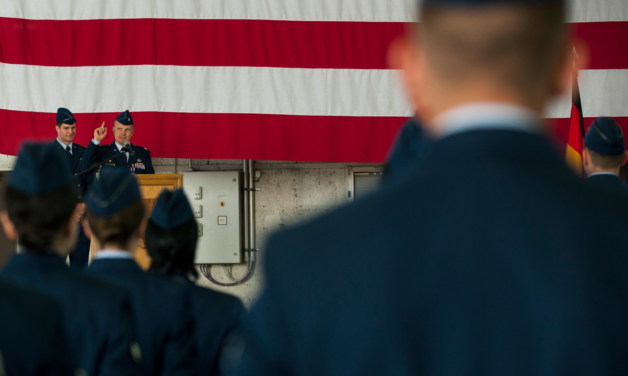 U.S. Air Force Lt. Col. Richard Atwell, the outgoing 52nd Comptroller Squadron commander, gives a speech during the 52nd CPTS change of command ceremony in Hangar One on Spangdahlem Air Base, Germany, June 26, 2015. Atwell thanked the members of his former squadron for giving him a chance to serve as their commander. (U.S. Air Force photo by Airman 1st Class Timothy Kim/Released)