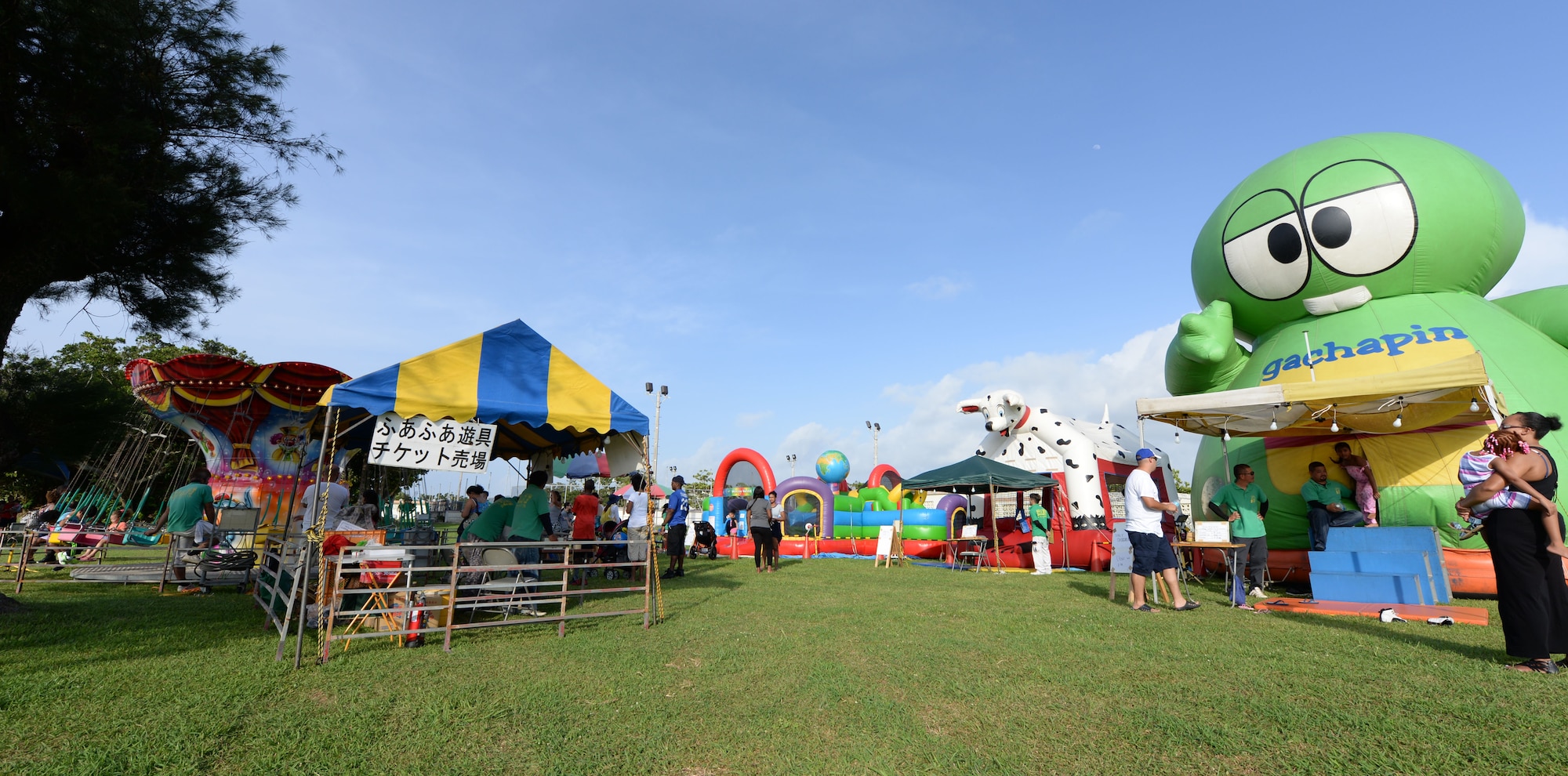 Status of Forces Agreement personnel and their families play at ‘kiddie land’ during Rockin’ the Block on Kadena Air Base, Japan, June 27, 2015. The event offered bouncy houses and rides for children. (U.S. Air Force photo by Senior Airman Omari Bernard)