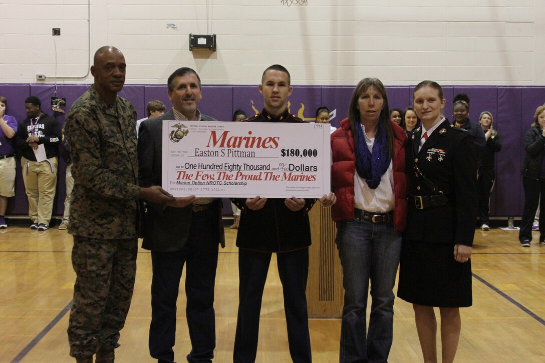 Easton Pittman, a senior from Franklinton High School, is presented an $180,000 scholarship as part of the Marine Option Naval Reserve Officer Training Corps program during an awards assembly held at Franklinton High School, Feb. 20. The scholarship being presented by gives Pittman the opportunity to attend one of over 150 universities and colleges while working towards earning a commission as a 2nd Lieutenant in the Marine Corps. 