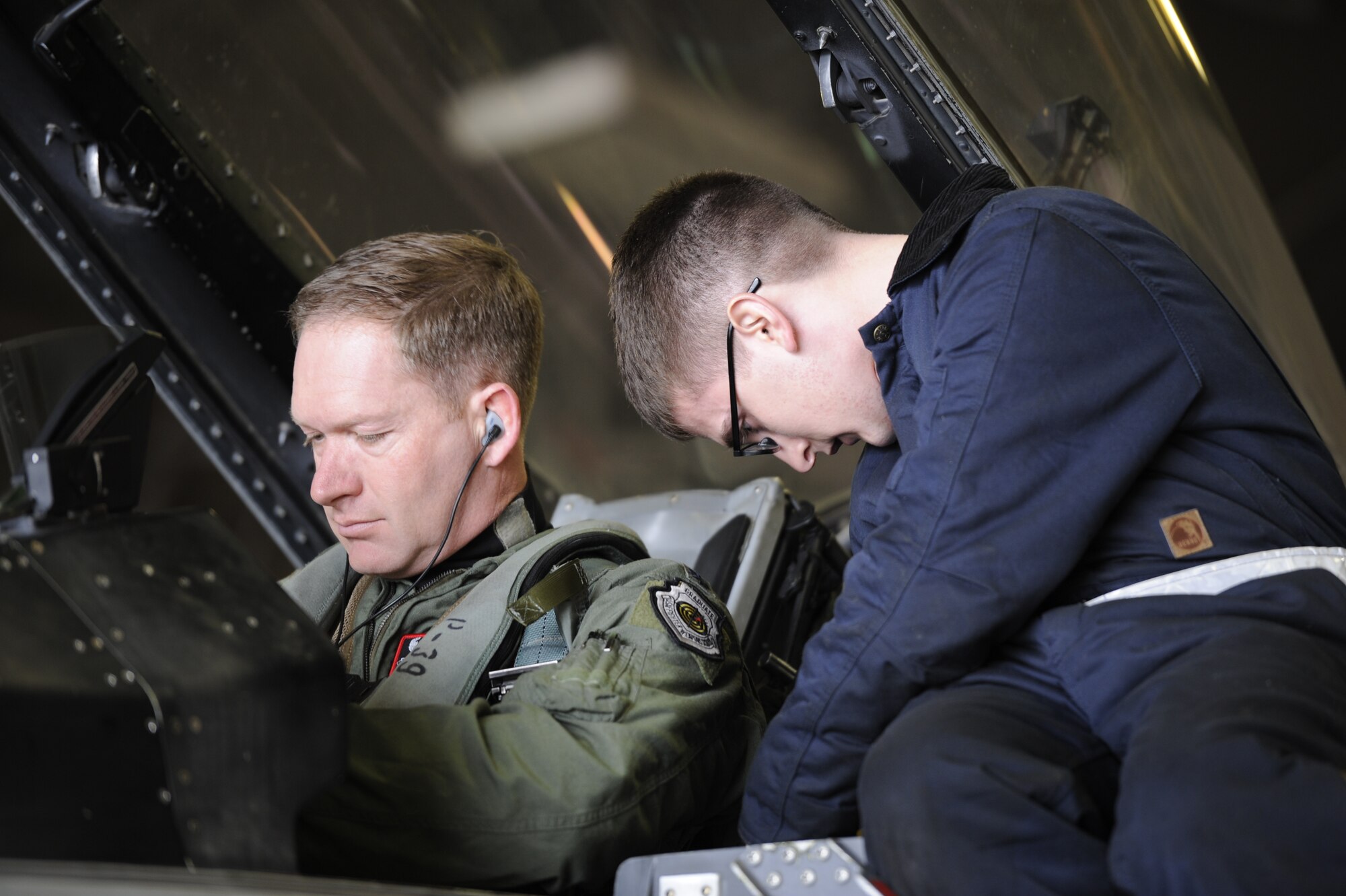 U.S. Air Force Airman 1st Class Jacob Dudley, 35th Aircraft Maintenance Squadron crew chief, assists U.S. Air Force Lt. Col. Kristopher Struve, 13th Fighter Squadron commander, by helping strap him into the cockpit of an F-16 Fighting Falcon at Misawa Air Base, Japan, March 1, 2015. The generation of aircraft was conducted as part of exercise Beverly Sunrise 15-2, which is designed to ensure Misawa Airmen are prepared to react to real-world contingencies. (U.S. Air Force photo by Airman 1st Class Jordyn Rucker/Released)