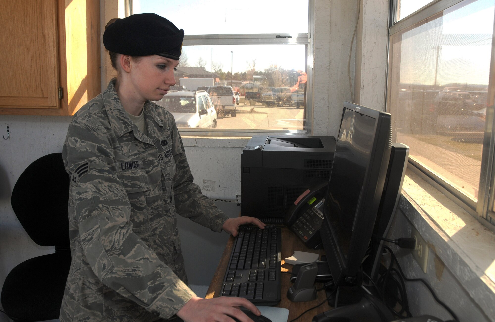 Senior Airman Kylie Lowder, 188th Security Forces Squadron, works on the Defense Biometric Identification System Feb. 7, 2015, at Ebbing Air National Guard Base, Fort Smith, Ark. Lowder was selected as The Flying Razorback Spotlight for March 2015. (U.S. Air National Guard photo by Senior Airman Cody Martin/released)