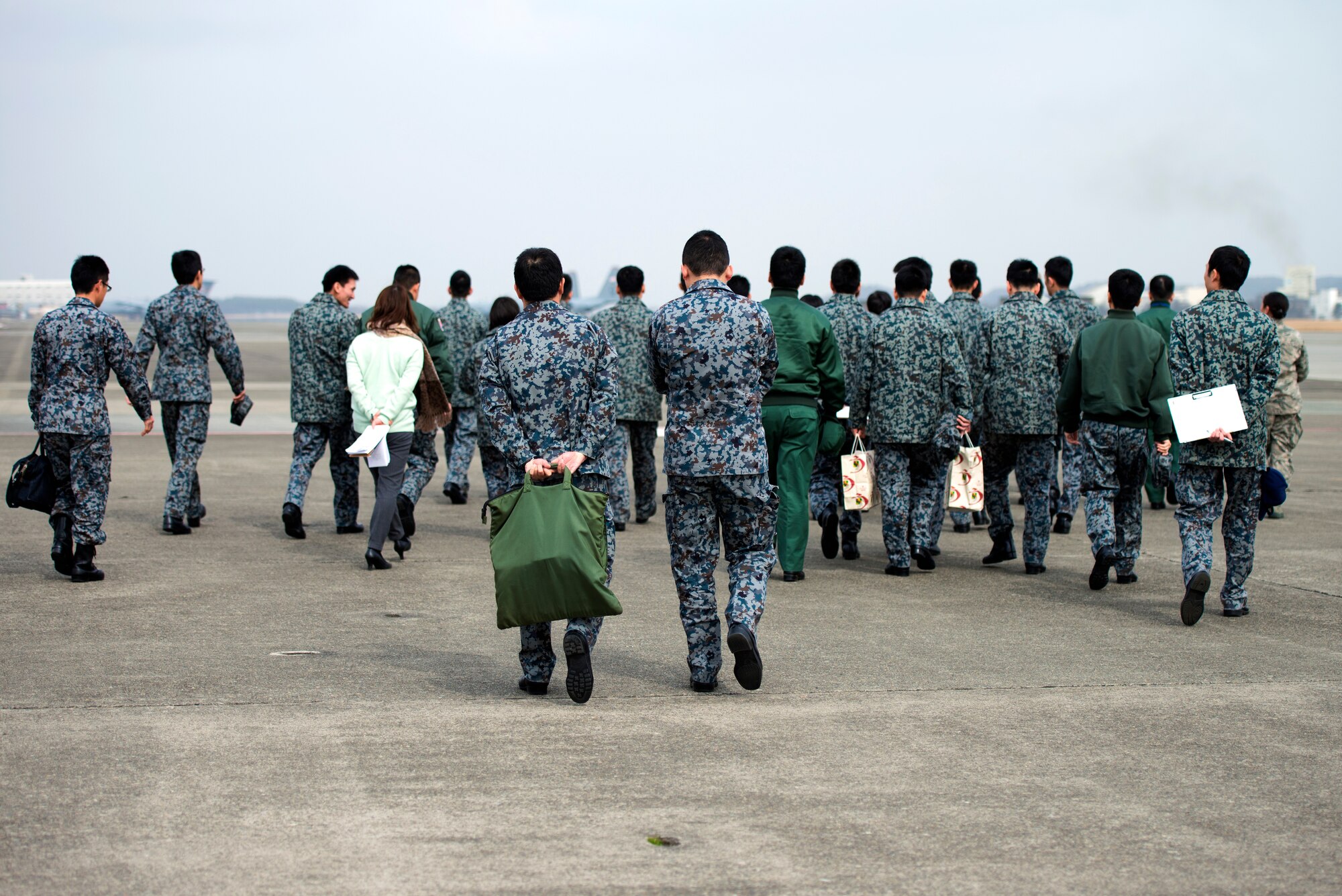 Japan Air Self-Defense Force basic maintenance officer students view U.S. Air Force flightline maintenance operations at Yokota Air Base, Japan, Feb. 25, 2015. JASDF basic maintenance officer students toured the 374th Maintenance Group to learn the similarities and differences between the two forces. (U.S. Air Force photo by Airman 1st Class Delano Scott/Released)