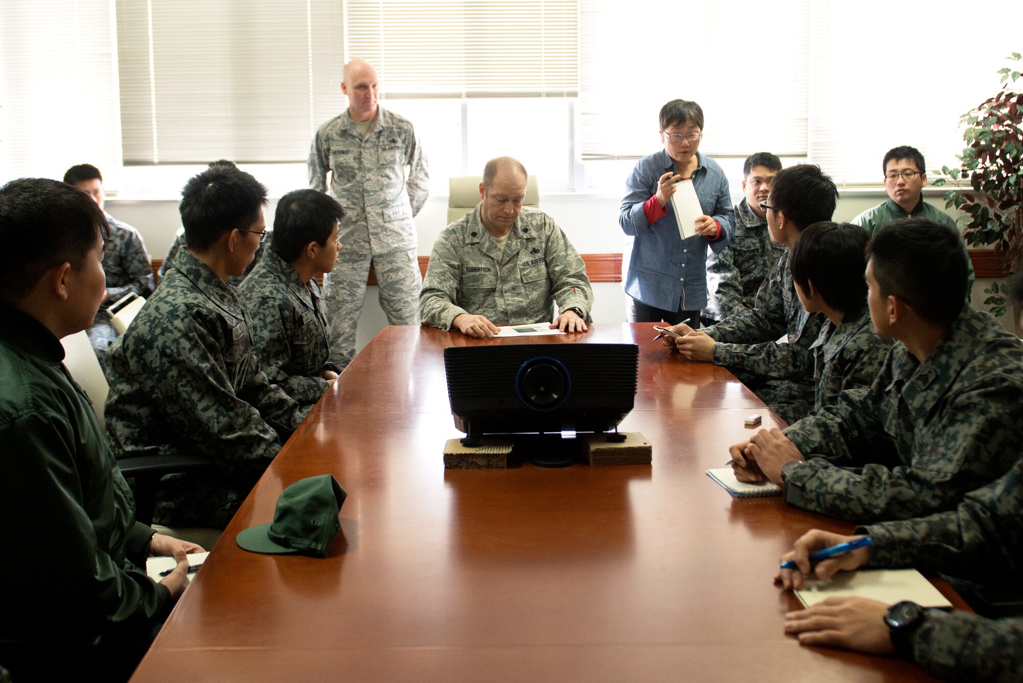 Lt. Col. Sean Robertson, 374th Maintenance Group deputy commander, briefs Japan Air Self-Defense Force maintenance officer students at Yokota Air Base, Japan, Feb. 25, 2015. As students of JASDF basic maintenance officer school, these Airmen visited Yokota to tour and learn from an operational maintenance squadron. (U.S. Air Force photo by Airman 1st Class Delano Scott/Released)
