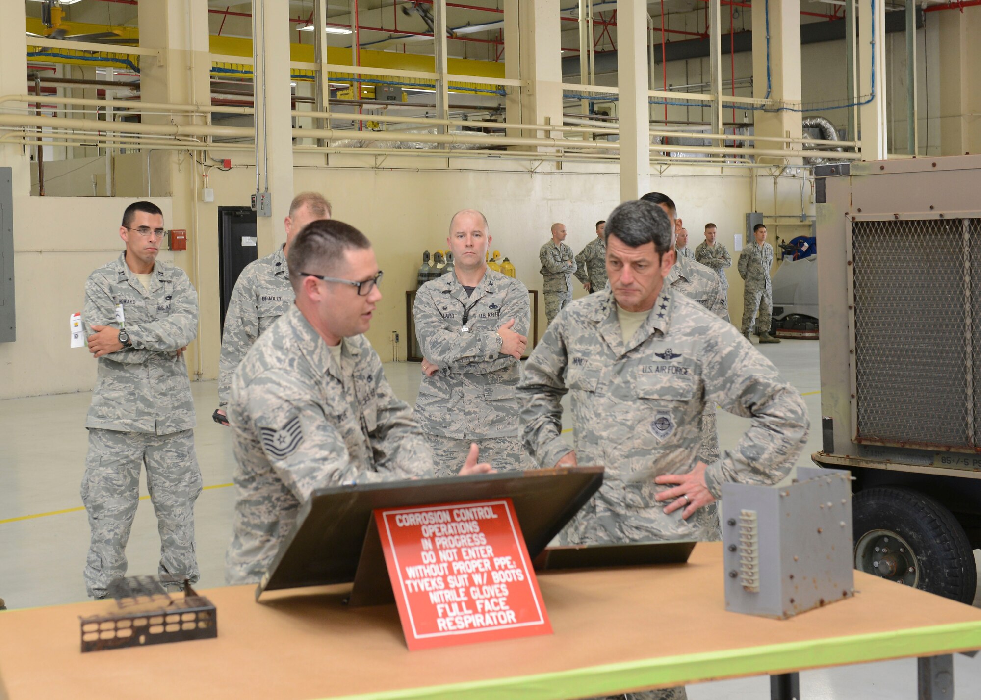 Tech. Sgt. Bradley Bove, 36th Maintenance Group, gives Lt. Gen. Russell Handy, 11th Air Force commander, a tour of the Corrosion Control Facility Feb. 27, 2015, at Andersen Air Force Base, Guam. During his week-long tour, he also visited different squadrons around Andersen and held an Airman’s call to discuss the strategic rebalance of the Pacific. (U.S. Air Force photo by Airman 1st Class Arielle Vasquez /Released)