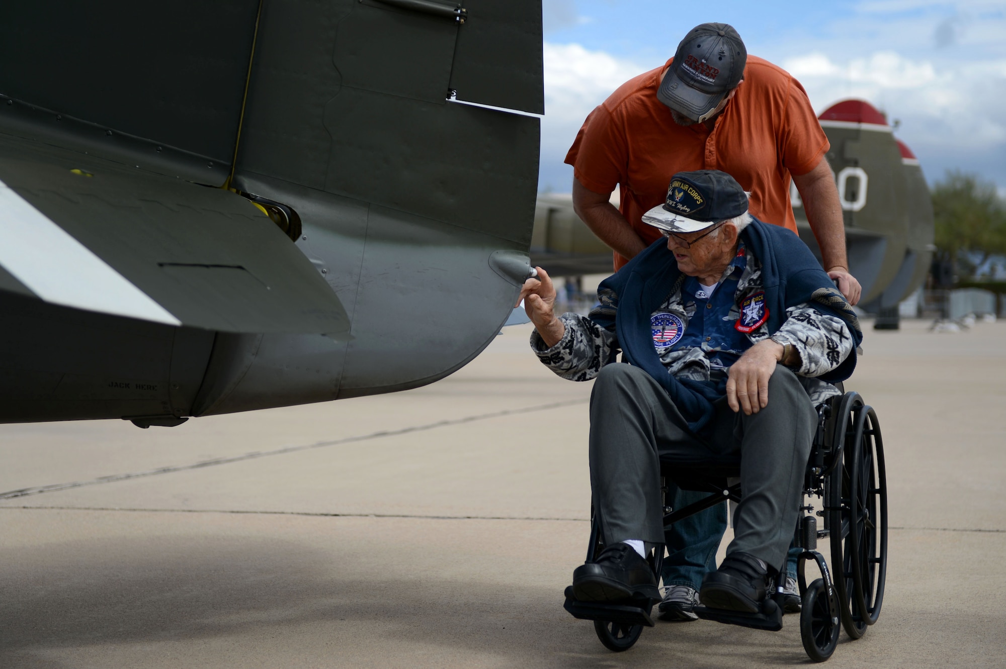 Retired Air National Guard Chief Warrant Officer 2 Robert Hertel touches a P-47 Thunderbolt for one the first times the 1960's during the Heritage Flight Training and Certification Course at Davis-Monthan Air Force Base, Ariz., Feb. 28, 2015. Hertel was given the opportunity to visit the aircraft as well as received praise from U.S. Air Force Gen. Hawk Carlisle, Commander of Air Combat Command, for his contributions to America. (U.S. Air Force photo by Senior Airman Jensen Stidham/Released)