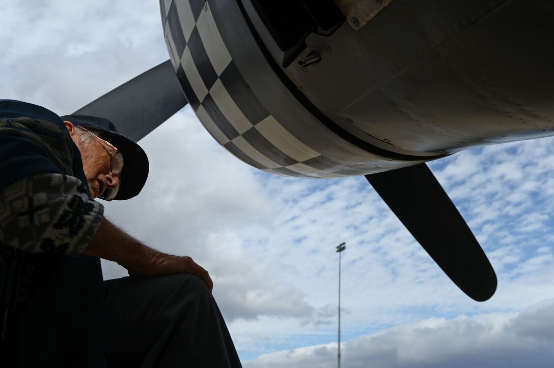 Retired Air National Guard Chief Warrant Officer 2 Robert Hertel looks at a P-47 Thunderbolt for one of the first times since the 1960's during the Heritage Flight Training and Certification Course at Davis-Monthan Air Force Base, Ariz., Feb. 28, 2015. Hertel flew the Thunderbolt over Iwo Jima, Japan during World War II. (U.S. Air Force photo by Senior Airman Jensen Stidham/Released)