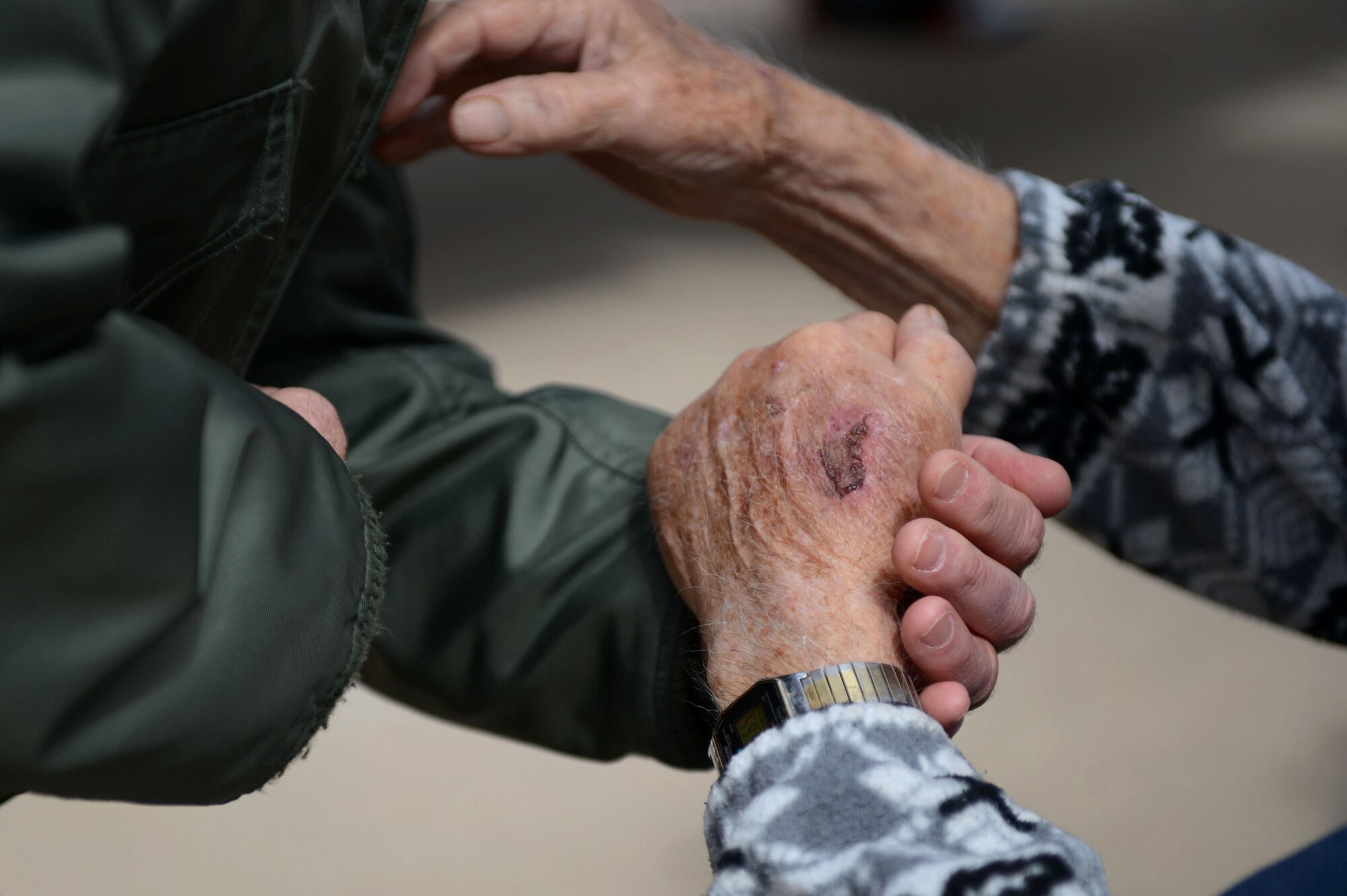 U.S. Air Force Gen. Hawk Carlisle, Commander of Air Combat Command grabs hands with retired Air National Guard Chief Warrant Officer 2 Robert Hertel during the Heritage Flight Training and Certification Course at Davis-Monthan Air Force Base, Ariz., Feb. 28, 2015. Hertel was given the opportunity to visit the P-47 Thunderbolt as well as visit with Gen. Carlisle and two P-47 Heritage Flight pilots. (U.S. Air Force photo by Senior Airman Jensen Stidham/Released)