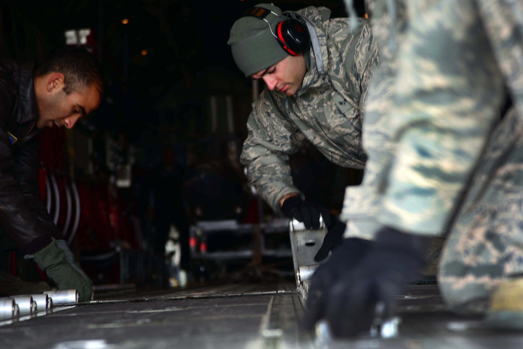 Loadmasters from the 146th Airlift Wing of the California Air National Guard prepare a C-130 Hercules for a cargo load during an Operational Readiness Exercise at Misawa Air Base, Japan, March 1, 2015. The C-130s flew in from California to support Exercise Beverly Sunrise 15-2, a weeklong operation that deployed Misawa Airmen and cargo to the Republic of Korea. (U.S. Air Force photo by Staff Sgt. Derek VanHorn/Released)