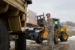 Spc. James Harmon, with the Kentucky Army National Guard’s Company A, 1st Battalion, 149th Infantry Regiment, helps guide a pallet of water into a vehicle for distribution in Harlan, Kentucky, Feb. 24. Members of the Kentucky Army Guard have been on duty throughout the eastern and southern portions of the state assisting with clearing roads, emergency response and distribution of food, water and other supplies to those hardest hit by winter storms that moved through the area recently. Guard members in Arkansas and Virginia have been called out as well in response to winter weather that affected those areas.