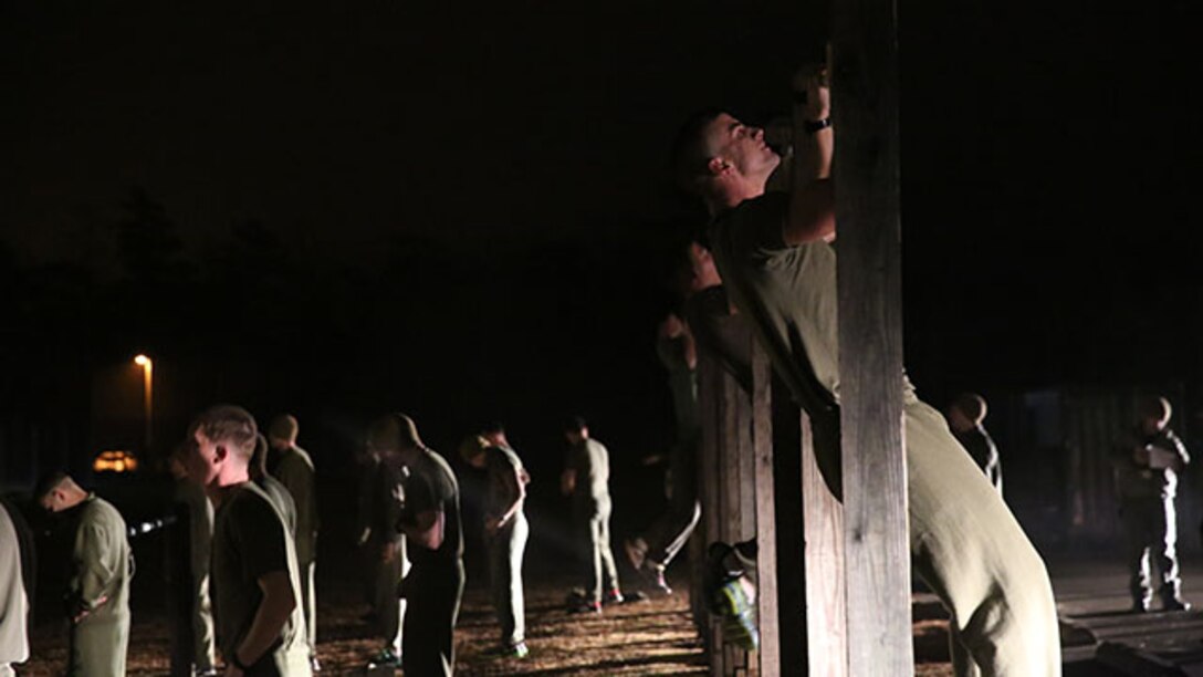 Marine perform pull-ups during Phase I of the U.S. Marine Corps Forces Special Operations Command's Assessment and Selection course aboard Marine Corps Base Camp Lejeune, N.C., Jan. 5, 2015. Completing a physical fitness test with a minimum score of 225 is a requirement to become a Critical Skills Operator with MARSOC.