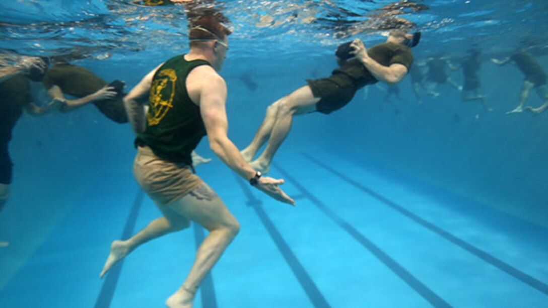 Marines build their strength in the water during a water physical training session of Phase I of the U.S. Marine Corps Forces Special Operations Command's Assessment and Selection course aboard Marine Corps Base Camp Lejeune, N.C., Jan. 30, 2015. Marines must successfully complete several qualifications with varying criteria, during the course.