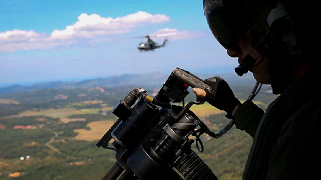 U.S. Marine Corps Sgt. Benjamin Hebert, a UH-1Y Huey crew chief, gets ready to fire the GAU-17/A Gatling gun Feb. 27 during a theater security cooperation event. U.S. Marines hosted the event for Malaysian Armed Forces members and civilians. Hebert is from Bothell, Washington, and is with Marine Medium Tiltrotor Squadron 262, 31st Marine Expeditionary Unit. The 31st MEU is the only continuously forward deployed MEU and is currently conducting Spring Patrol 2015 of the Asia-Pacific region.