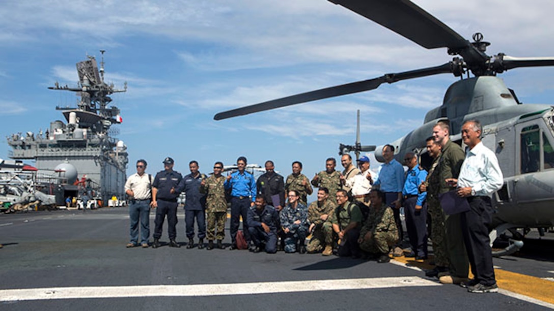 Members of the Malaysia Armed Forces, alongside Malaysian government officials and U.S. service members, pose for a group photo in front of a UH-1Y Huey here Feb. 27 during a theater security cooperation event. After watching a live-fire demonstration, the MAF members and other Malaysian dignitaries flew to the USS Bonhomme Richard (LHD 6) via an MV-22B Osprey to tour the ship. The Marines are with Battalion Landing Team 2nd Battalion, 4th Marines, and Marine Medium Tiltrotor Squadron 262, 31st Marine Expeditionary Unit, and are currently conducting the annual Spring Patrol of the Asia-Pacific region.