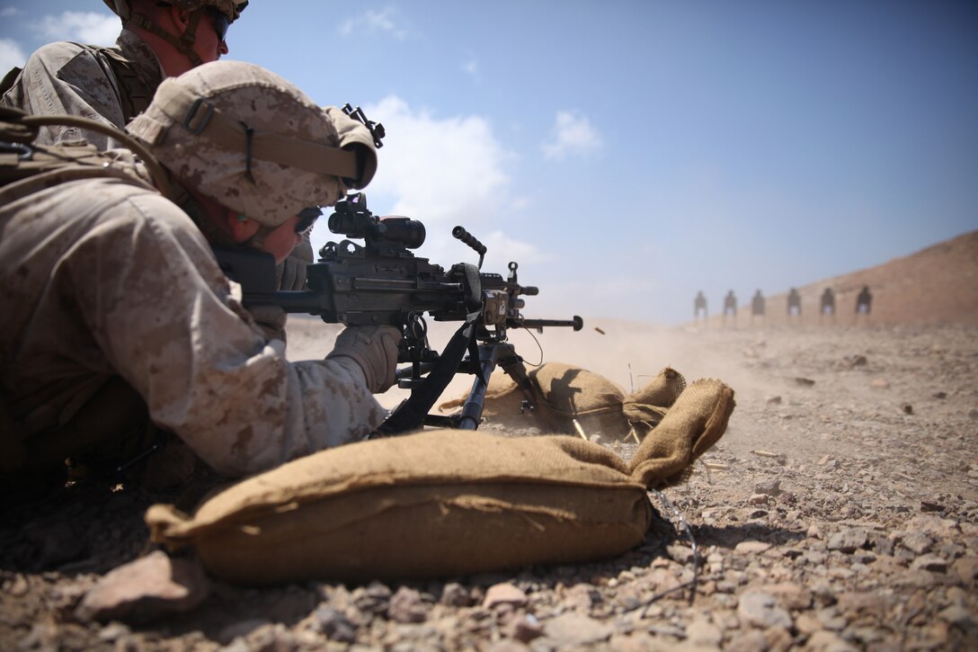 A Marine with Battalion Landing Team 3rd Battalion, 6th Marine Regiment, 24th Marine Expeditionary Unit, fires his M249 Squad Automatic Weapon during a live-fire machine gun range in Djibouti, Feb. 18, 2015. A contingent of MEU Marines was ashore in Djibouti conducting sustainment training in order to maintain proficiency while deployed. The 24th MEU is embarked on the ships of the Iwo Jima Amphibious Ready Group and deployed to maintain regional security in the U.S. 5th Fleet area of operations.