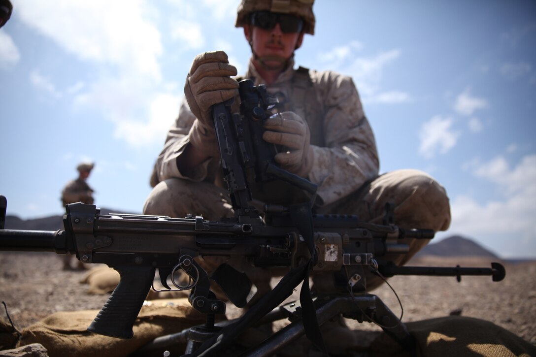 A Marine with Battalion Landing Team 3rd Battalion, 6th Marine Regiment, 24th Marine Expeditionary Unit, adjusts the sights on an M249 Squad Automatic Weapon during a live-fire machine gun range in Djibouti, Feb. 18, 2015. A contingent of MEU Marines was ashore in Djibouti conducting sustainment training in order to maintain proficiency while deployed. The 24th MEU is embarked on the ships of the Iwo Jima Amphibious Ready Group and deployed to maintain regional security in the U.S. 5th Fleet area of operations.