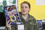 Airman 1st Class Hannah Bartlett, 108th Wing, New Jersey Air National Guard, reads Peggy Rathmann's "Officer Buckle and Gloria" to a group of fifth graders at the Brighton Avenue School, Atlantic City, during the Read Across America event on Feb. 24, 2015. Five NJANG Airmen participated in this year’s event at the school. Read Across America is an 18-year-old national initiative sponsored by the National Education Association to encourage young people to read by holding special reading events involving military and community members.