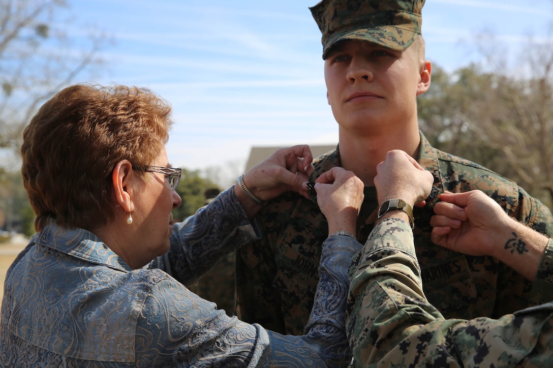 U.S. Marine Corps Sgt. Kalab Johnson, right, 22nd Marine Expeditionary Unit (MEU) embark noncommissioned officer in charge and native of Pierre Part, La., is pinned to his current rank by his grandmother, Delta Channey, at Marine Corps Base Camp Lejeune, N.C., March 2, 2015. (U.S. Marine Corps photo by Cpl. Caleb McDonald/Released)