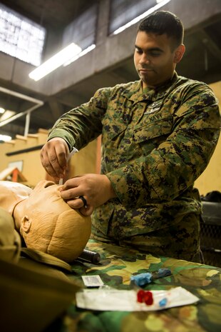 Petty Officer 2nd Class Andy Gil, a field medical service technician with 2nd Medical Battalion, 2nd Marine Logistics Group, practices placing a nasopharyngeal airway on a simulated casualty during a week-long Tactical Combat Casualty Care course aboard Marine Corps Base Camp Lejeune, N.C., Feb. 25, 2015. The nasopharyngeal airway opens up the casualty’s airway, allowing them to maintain an open airway until at a more advanced treatment facility, where it will be replaced. (U.S. Marine Corps photo by Cpl. Krista James/Released)