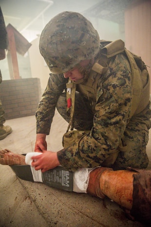 Seaman Jake McCurdy, a field service medical technician with 2nd Medical Battalion, 2nd Marine Logistics Group, places a splint on a simulated casualty during the culminating event for a week-long Tactical Combat Casualty Care course aboard Marine Corps Base Camp Lejeune, N.C., Feb. 26, 2015. The splint will hold the patient’s bone in place during transport to a follow-on treatment facility where more advanced care can be provided. (U.S. Marine Corps photo by Cpl. Krista James/Released)