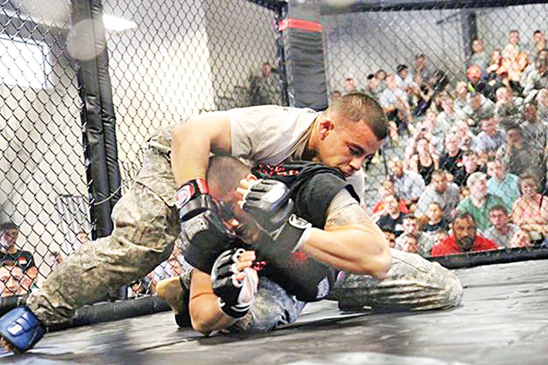 Staff Sgt. David Nakasone, a Ranger School graduate, 162nd EOD Company (left) competes in an Army Combatives tournament. 