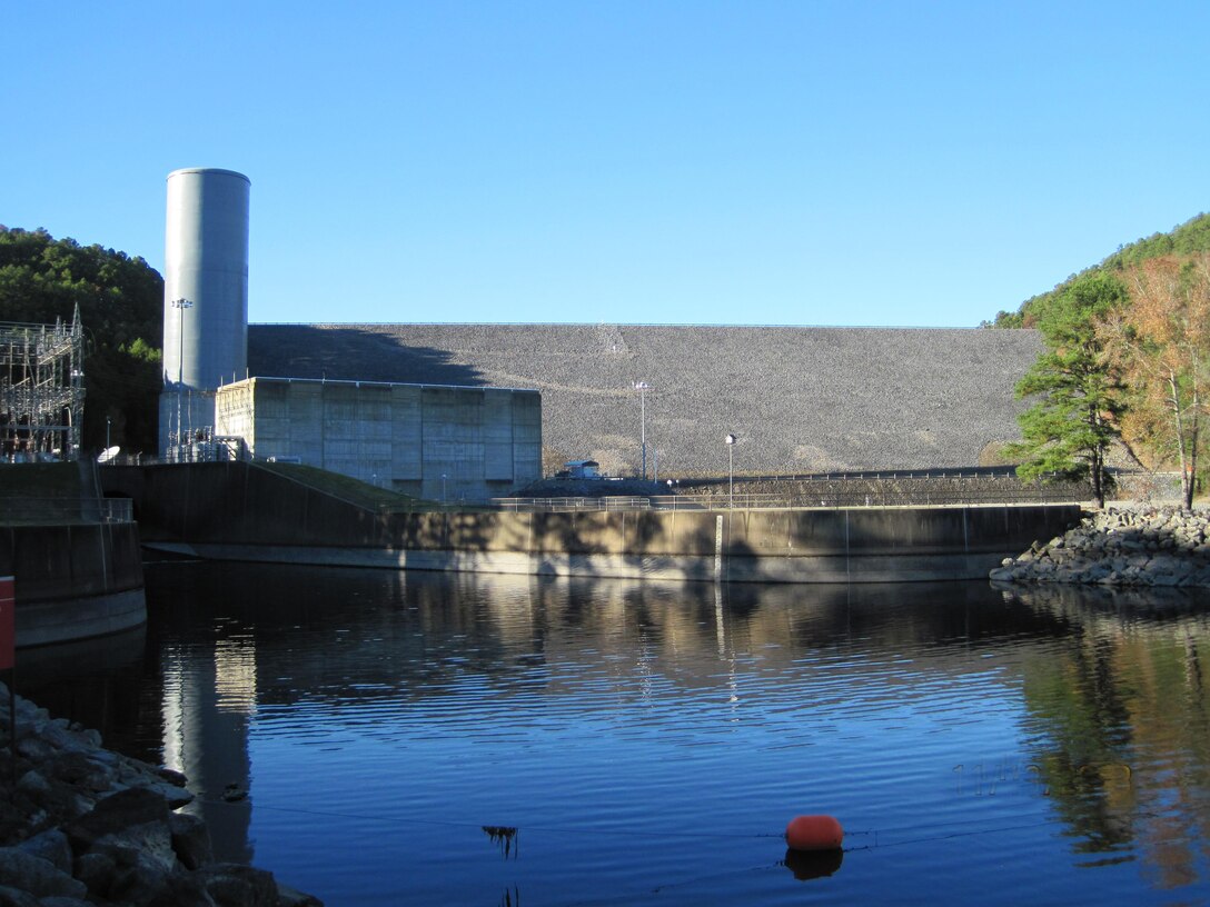 The LRL Risk Cadre team performs a site reconnaissance meeting for Blakely Mountain Dam, Royal, Arkansas. The project consists of a 231-foot-high earthen embankment dam with a hydropower power plant located in lower left of photo. 