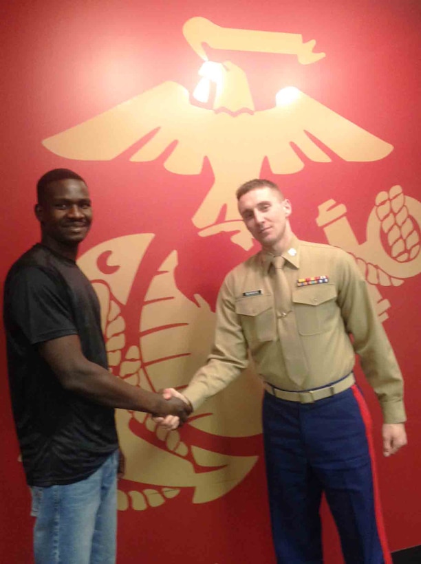Staff Sgt. Kon Biliu, a former Sudanese refugee (Left) shakes hands with Capt. Andrew Schroers, the officer selection officer with Marine Corps Recruiting Station Twin Cities (Right). Biliu, in addition to being a staff sergeant in the Marine Corps Reserve, is a full time college student working toward becoming a Marine Corps officer. 
