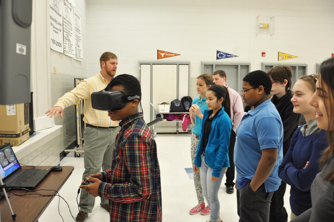 Students at Scott Middle School, Fort Knox, Ky., try on 3D goggles, which allow them to take a virtual tour of a designed school building as part of the Louisville District STEM ED initiative.