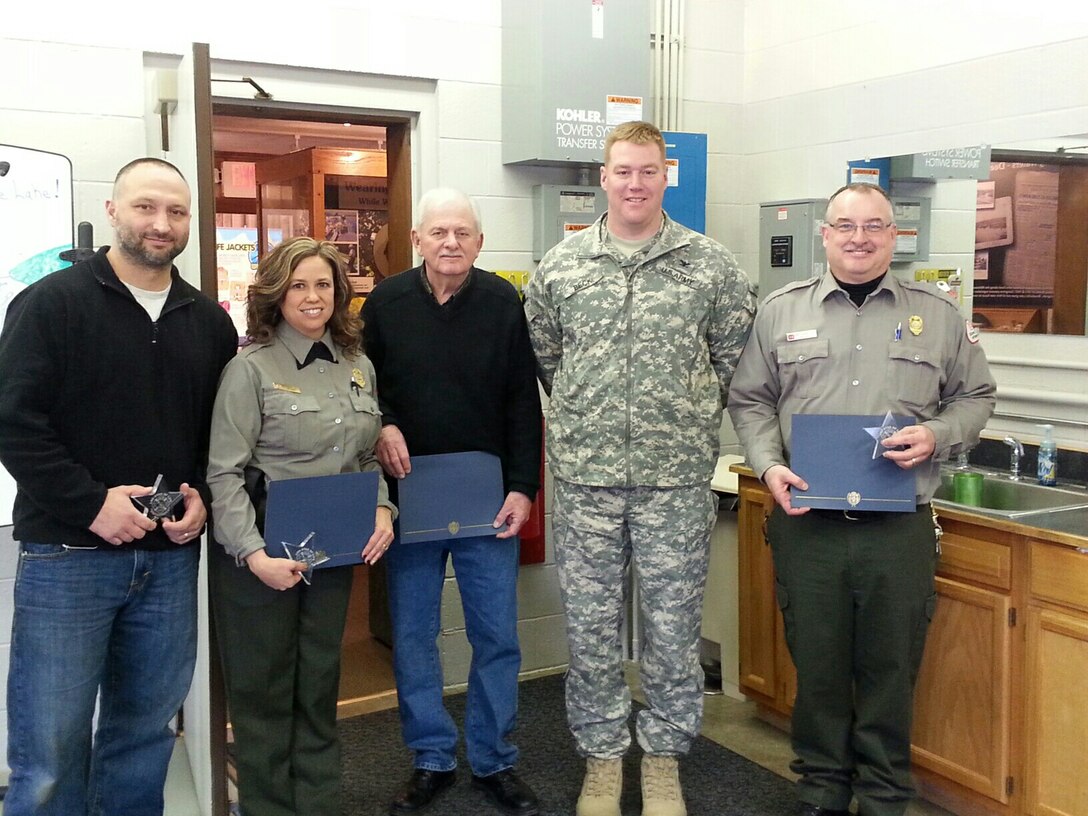 Louisville District Commander Col. Christopher Beck presented the Star of Life Award to Chris Bass, maintenance worker; Stephanie Ison, park ranger; David Stutzman, Corps retiree and volunteer; and David Johnstone, park manager, at Brookville Lake, Brookville, Ind.