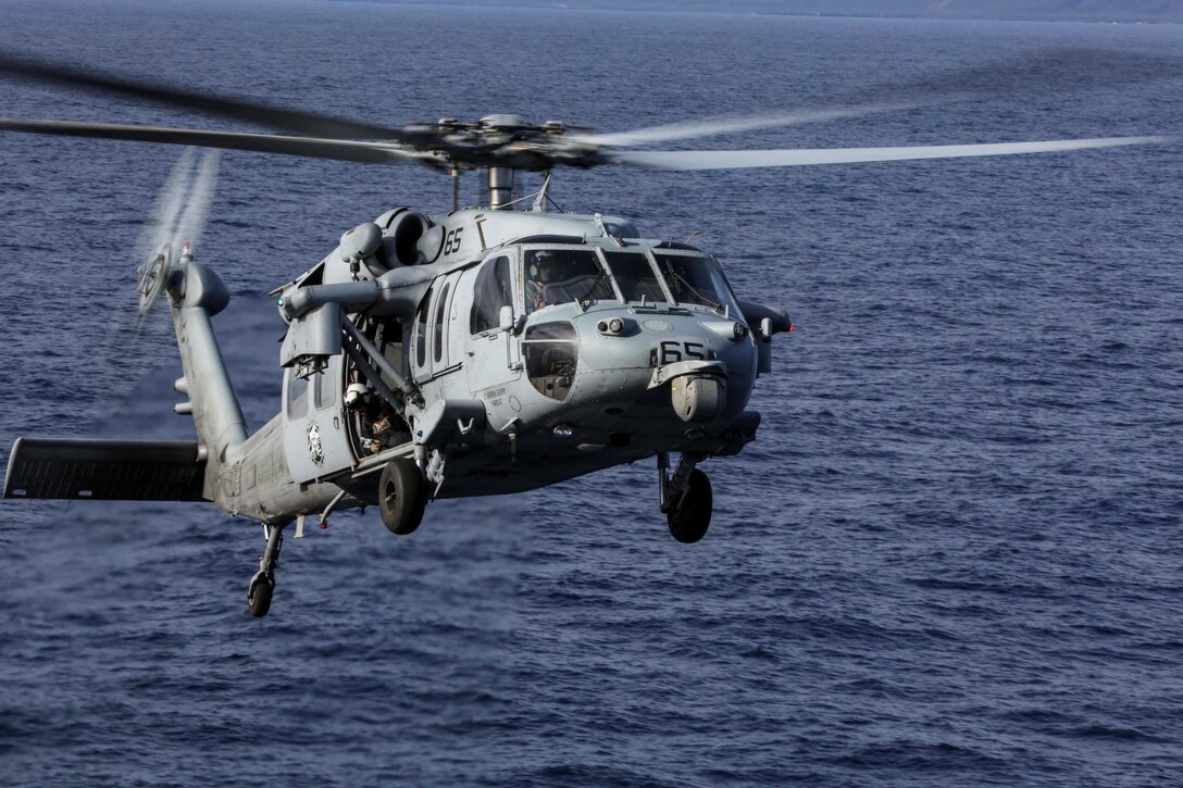 A U.S. Navy MH-60S Sea Hawk prepares to land on the USS Essex (LHD 2) during Amphibious Squadron/Marine Expeditionary Unit Integration Training (PMINT) off the coast of San Diego Feb. 28, 2015. This training gave the Marines and Sailors aboard the USS Essex a chance to work together while conducting landing and takeoff procedures at sea. (U.S. Marine Corps photo by Cpl. Anna Albrecht/ Released)