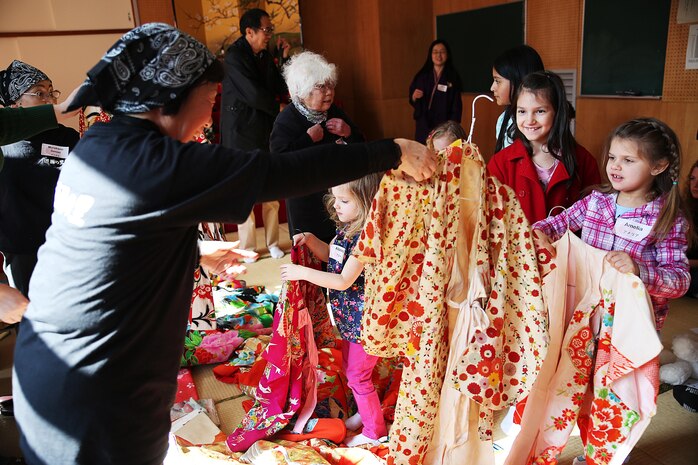 Yusu No Sato teachers help children from Marine Corps Air Station Iwakuni, Japan, dress in traditional Japanese kimonos during a hina doll festival in Iwakuni, City, Feb. 27, 2015. Coordinated by the Cultural Adaption Program aboard station, residents celebrated the festival “Hinamatsuri,” with Yusu No Sato by helping display “hina-ningyo,” a seven-tiered stand presenting the special dolls of Hinamatsuri that celebrates young girl’s growth and happiness, dressing in traditional Japanese kimonos, and making Iwakuni sushi.