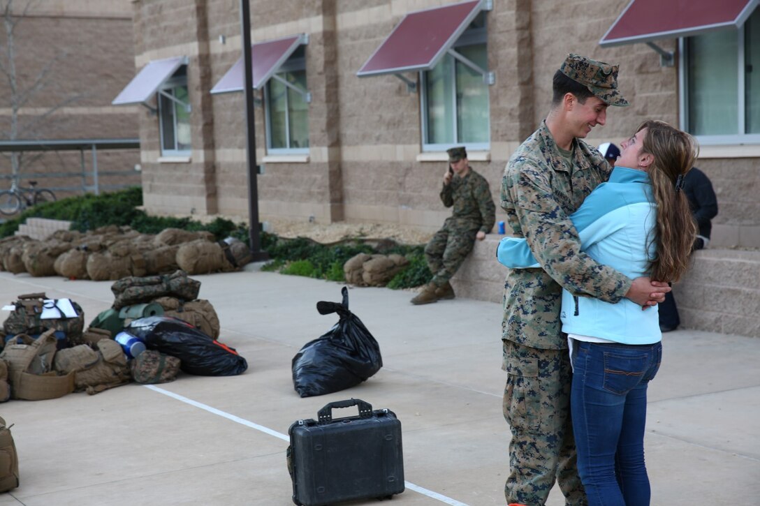 Corporal Christian B. Swanholm, a field artillery cannoneer with 1st Battalion, 11th Marine Regiment, 1st Marine Division, embraces his crying wife after a seven-month deployment aboard Marine Corps Base Camp Pendleton, Calif., Feb. 23, 2015. Marines arrived from the early hours of the morning until the late hours of the night to greet their family and friends.