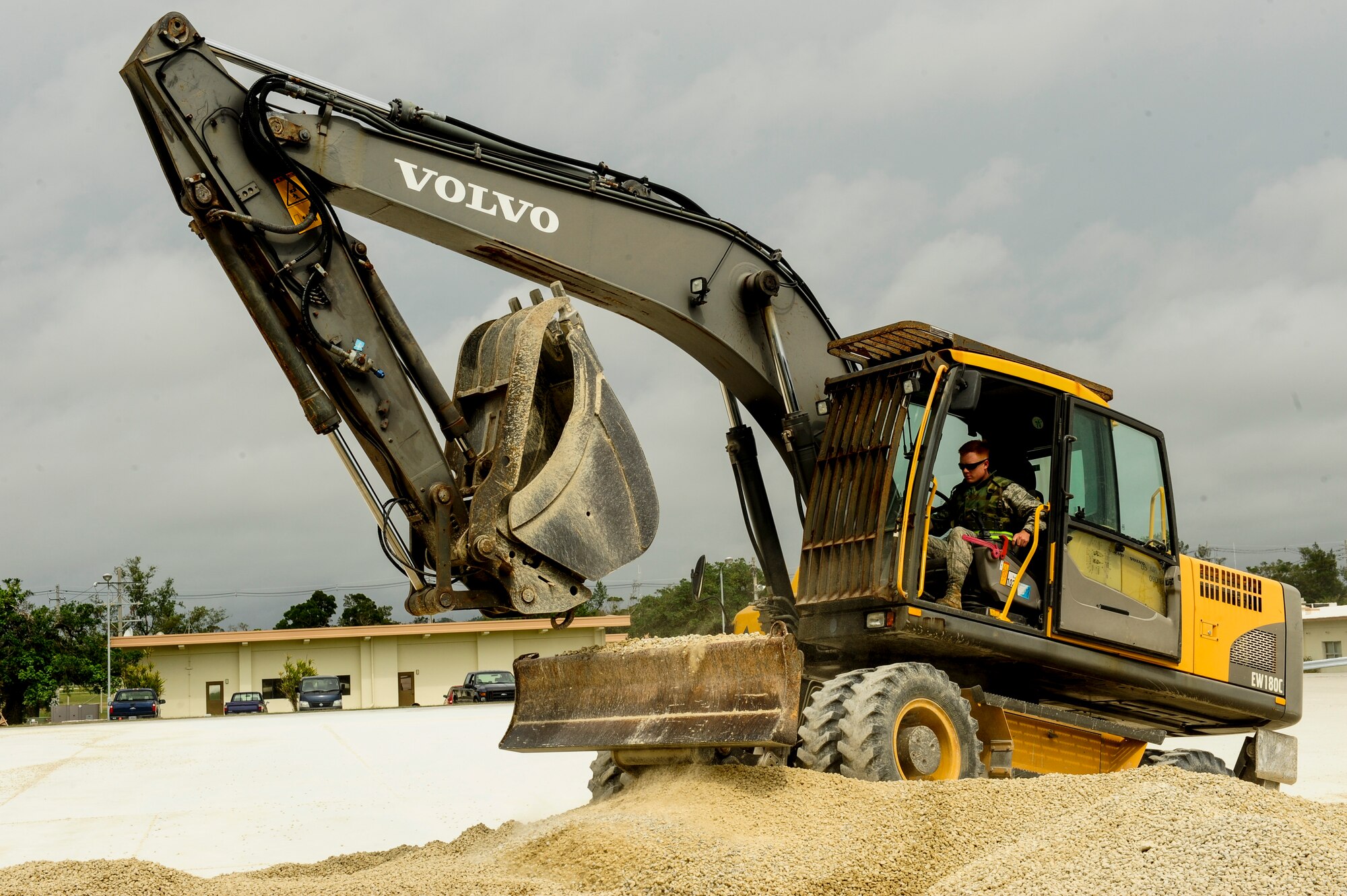 U.S. Air Force Airman 1st Class Jonathan Dale, 18th Civil Engineering Squadron pavement and equipment journeyman, operates an excavator during a joint airfield damage and repair contingency exercise at Kadena Air Base, Japan Feb. 26, 2015. Marines from 172nd and 171st Engineering Companies participated in a joint airfield damage and repair contingency exercise to learn how civil engineer Airmen respond to airfield damage and to strengthen joint capabilities in reestablishing an operational runway. (U.S. Air Force photo by Airman 1st Class John Linzmeier)