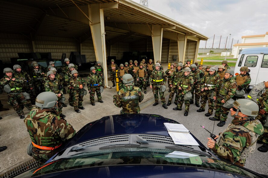 U.S. Air Force 2nd Lt. David Brown-Dawson, 18th Civil Engineer Squadron Airfield Damage and Repair officer in charge, delivers a safety briefing to Airmen and Marines at Kadena Air Base, Japan Feb. 26, 2015.  Marines from 172nd and 171st Engineering Companies joined Airmen during a joint airfield damage and repair contingency exercise. The exercise gave both services an opportunity to learn from each other and improve more effective ways to work together in a crisis situation. Portions of the image were blurred for security concerns (U.S. Air Force photo by Airman 1st Class John Linzmeier)