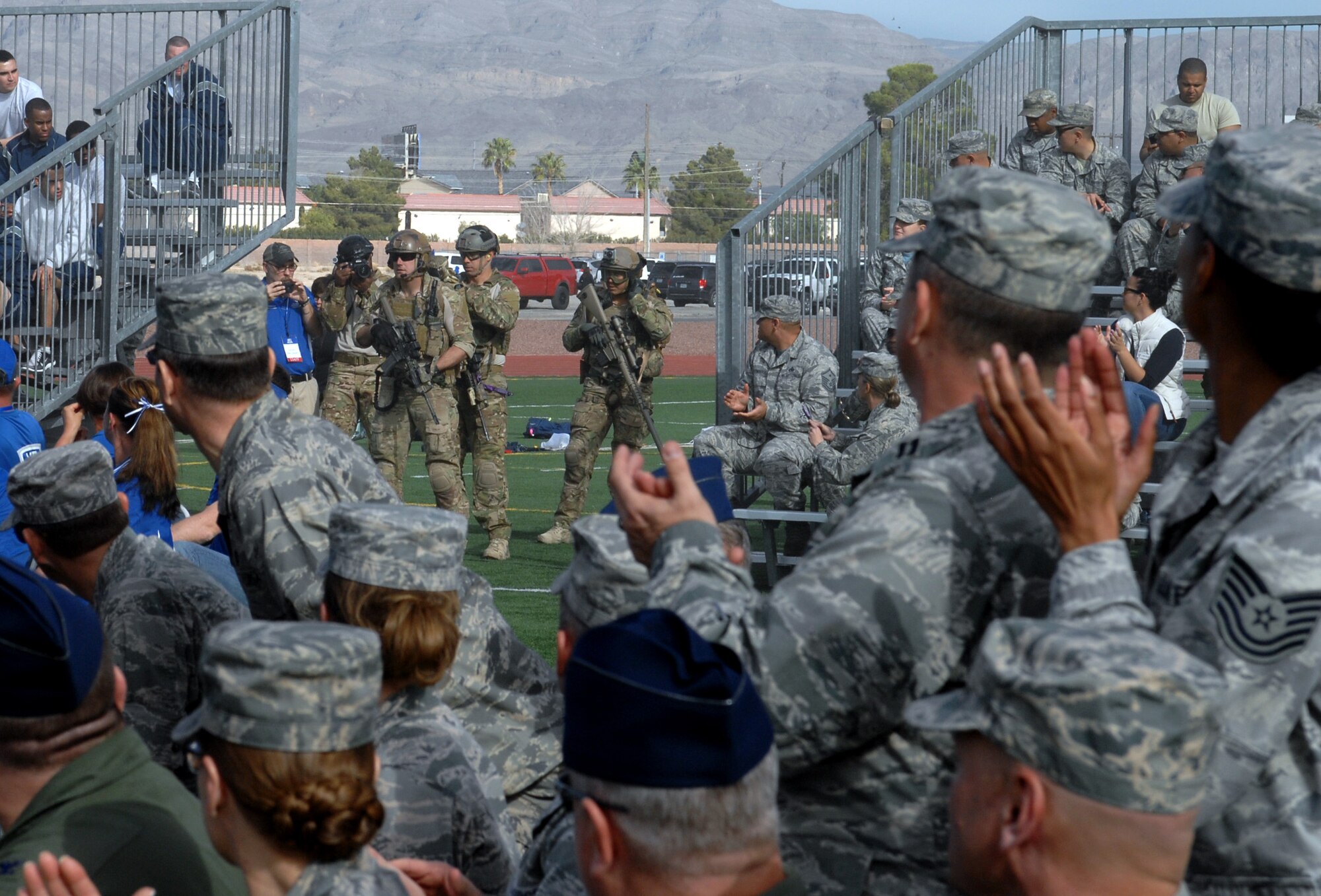 Staff Sgt. August O’Neil removes a Care Beyond Duty flag from a ruck to present during the opening cermony of the 2015 U.S. Air Force Trials at Nellis Air Force Base, Nev., Feb. 27, 2015. The Care Beyond Duty Flag was presented to Chief Master Sgt. Steven Cleveland, 99th Air Base Wing command chief, during the cermony as a sign of appreciation for the 99th ABW’s support. (U.S. Air Force photo by Staff Sgt. Jack Sanders)