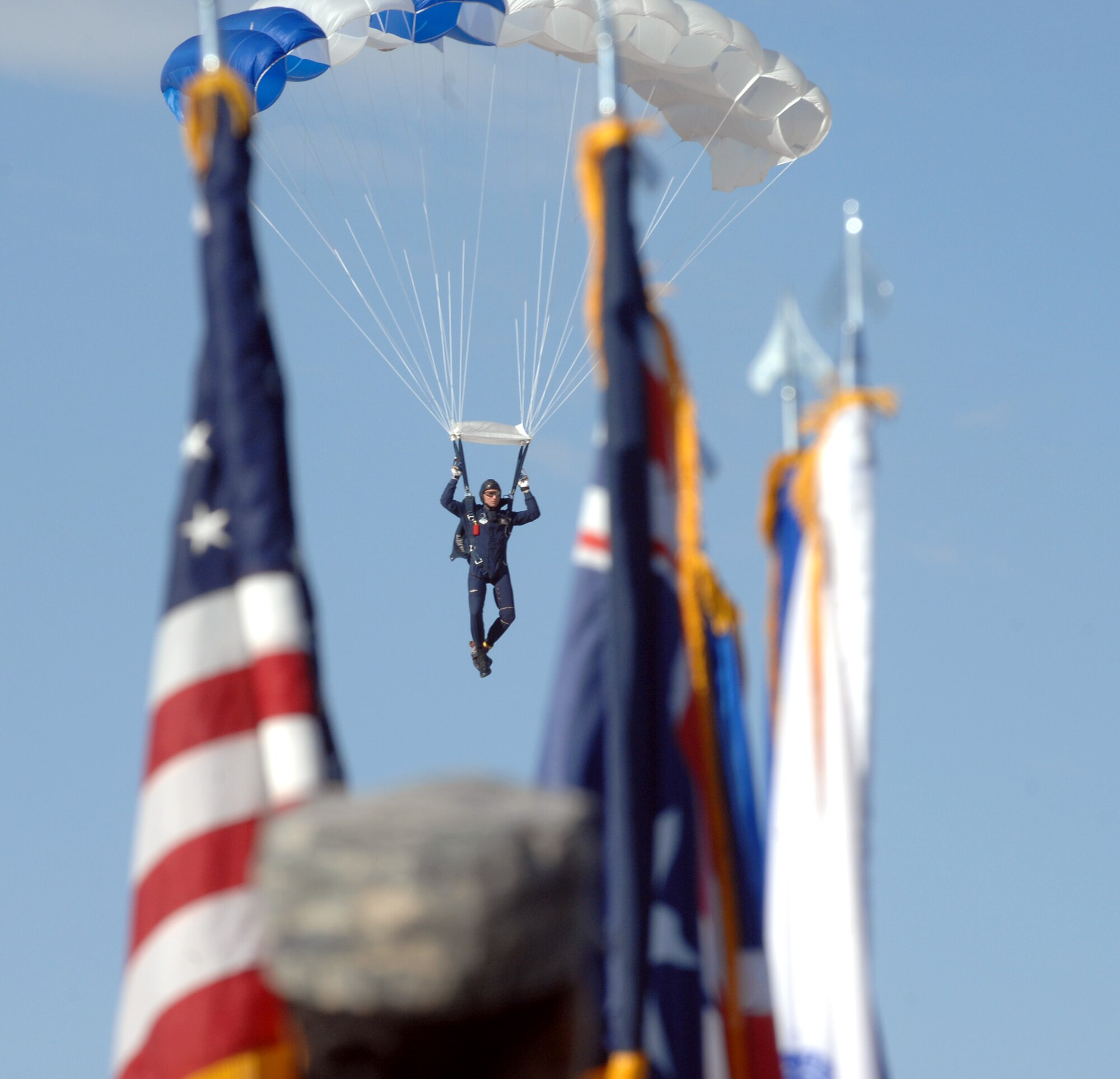 U.S. Air Force Master Sgt. Daniel McCaffrey, Wings of Blue Parachute Team member, prepares to land during the opening cermony of the 2015 U.S. Air Force Trials at Nellis Air Force Base, Nev., Feb. 27, 2015. Each year, the Wings of Blue conduct approxmiately 19,000 training jumps. (U.S. Air Force photo by Staff Sgt. Jack Sanders)
