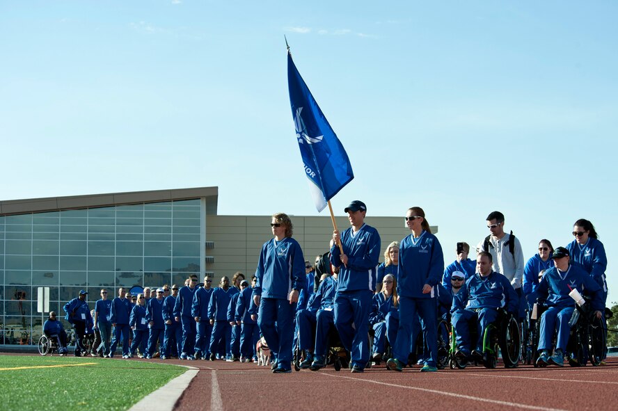 Members of the U.S. Air Force Wounded Warrior Trials Team walk toward their seats during their arrival to the opening ceremony of the 2015 Air Force Trials at Nellis Air Force Base, Nev., Feb. 27, 2015. More than 100 wounded, ill or injured service men and women from around the country will compete for a spot on the 2015 U.S. Air Force Wounded Warrior Team, which will represent the Air Force at the 2015 Warrior Games held in the fall, and at adaptive sports events throughout the year. (U.S. Air Force photo by Senior Airman Timothy Young)